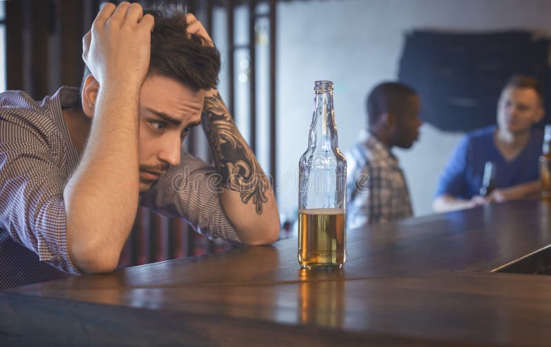 Troubled Young Man Sitting Alone at Bar Stock Image - Image of male ...