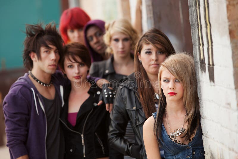 Gang of young teen punks stare seriously towards the camera. Gang of young teen punks stare seriously towards the camera.