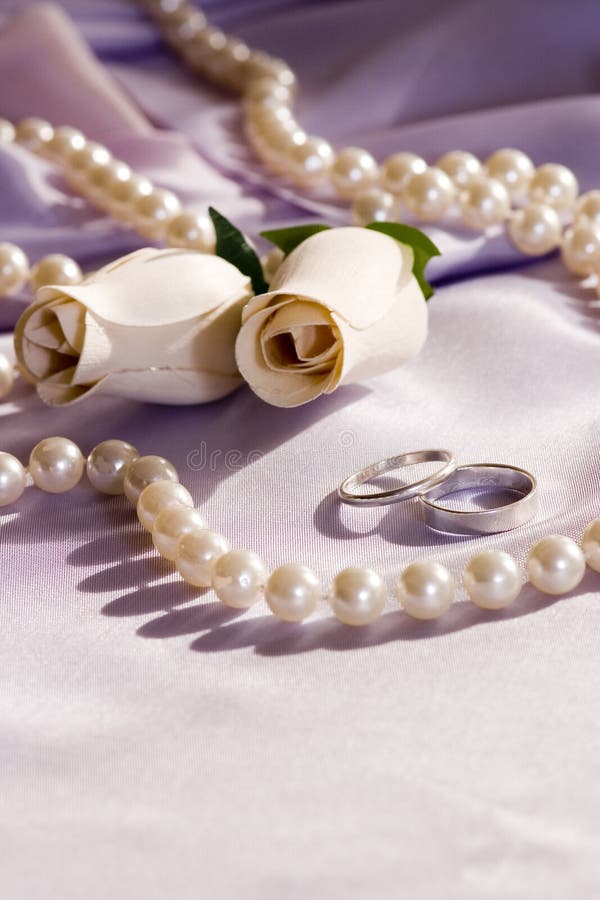 Wedding rings and roses over satin - different side. Wedding rings and roses over satin - different side
