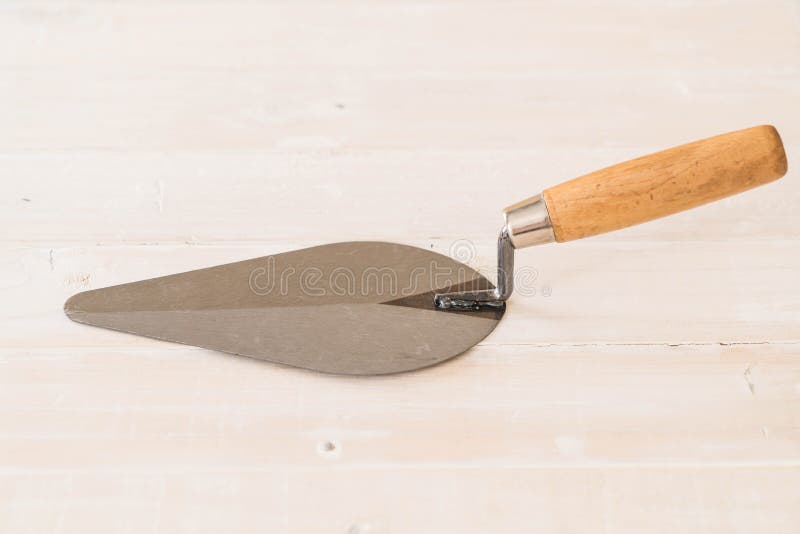 Trowel the mortar on wood stock photo. Image of site 96385868