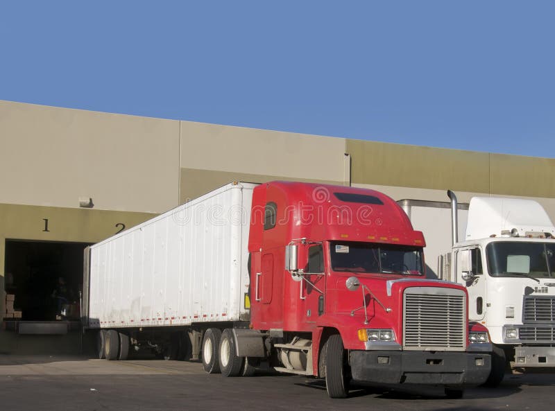Truck delivering to warehouse stock photos