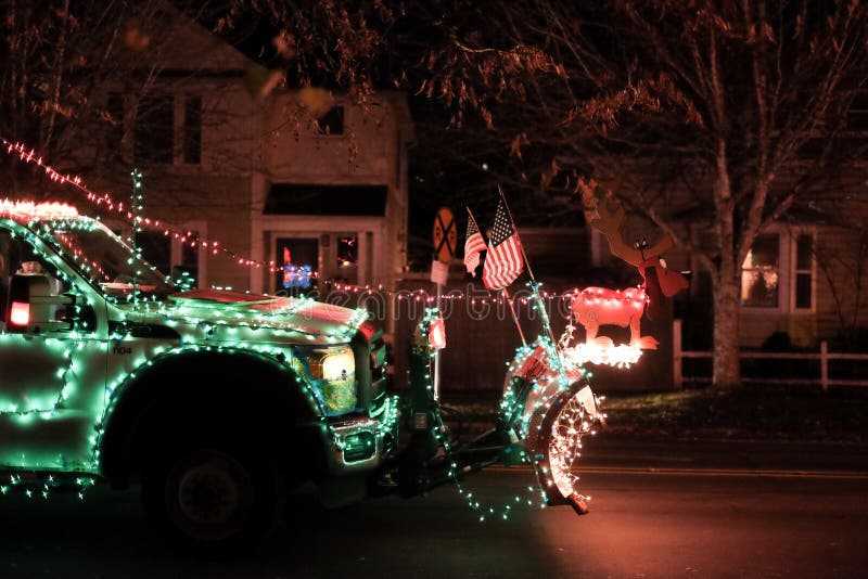 Truck hood with Grinch characters and US flags prepares for holiday parade