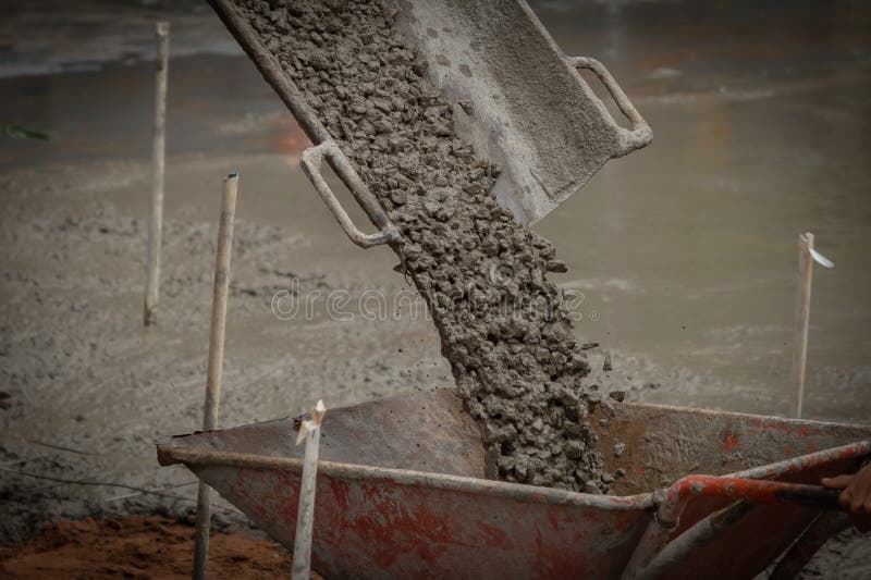 Truck operator pouring concrete into trolley royalty free stock photos Truck operator pouring concrete into trolley royalty free stock photos