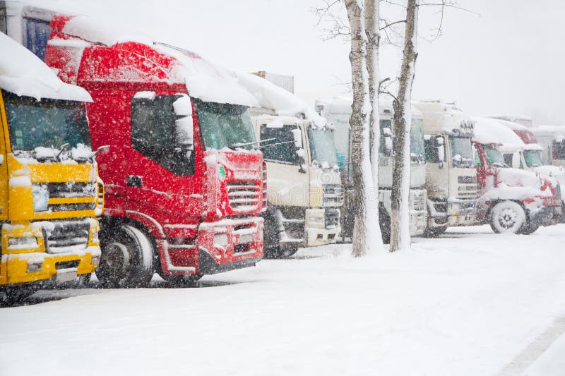 Trucks parking in severe winter weather storm. Prohibition of traffic in heavy snow