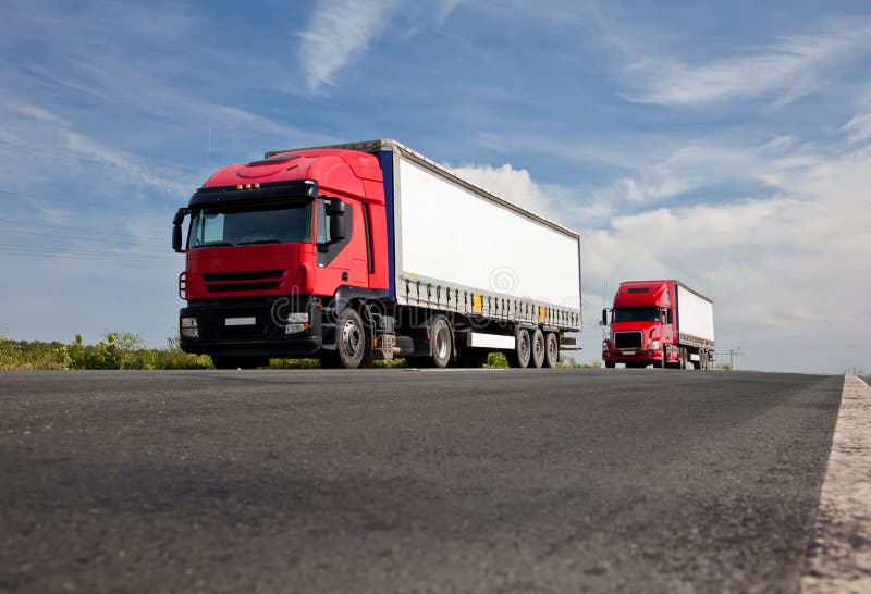 Trucks on the road stock photography