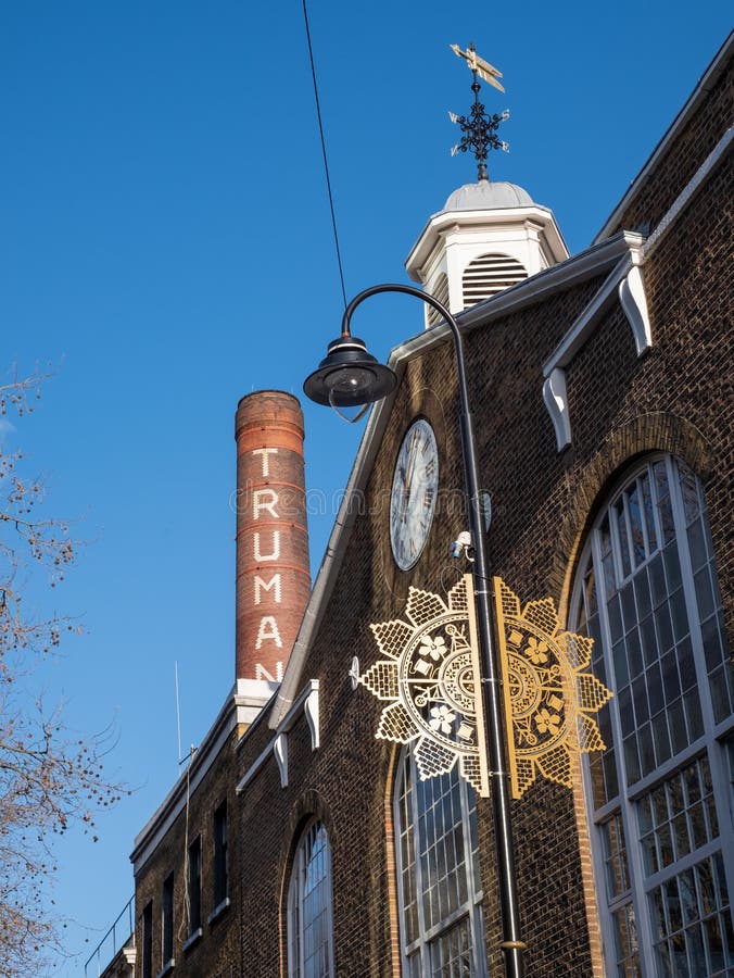 Truman Brewery building on Brick Lane, East London UK, with iconic chimney, now used as a retail, leisure and business event space