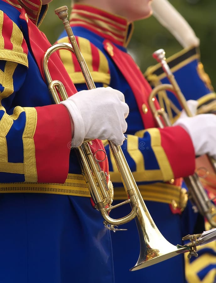 The person in military historicak suit holds a trumpet