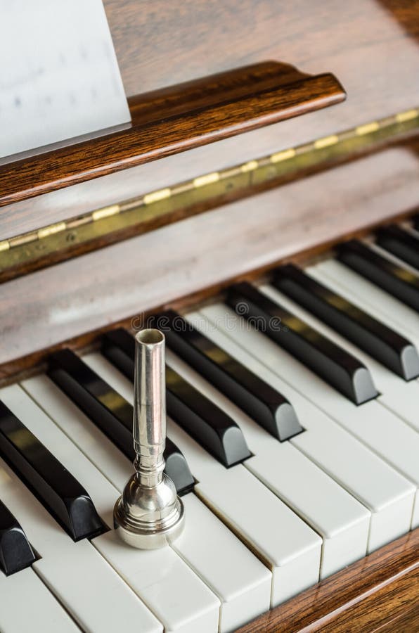 Trumpet Mouthpiece upon the Piano Keys, Close Up Stock Image Image of