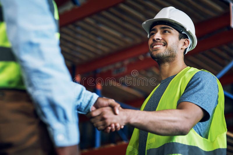 Trust, respect and reliability, everything great partnerships are built on. two builders shaking hands at a construction