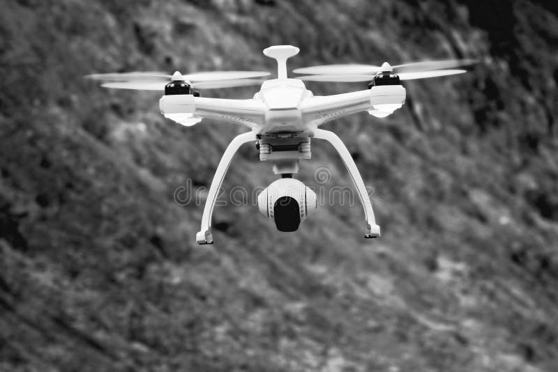 Close up shot of a drone flying with black and white background. Close up shot of a drone flying with black and white background