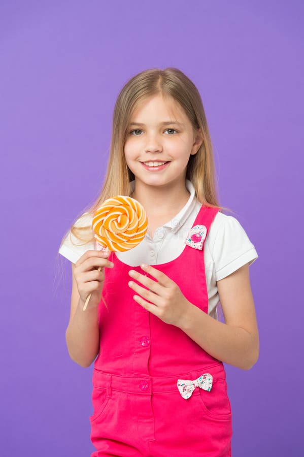 Try My Lollipop! Small Child Smiling with Candy on Stick on Purple ...