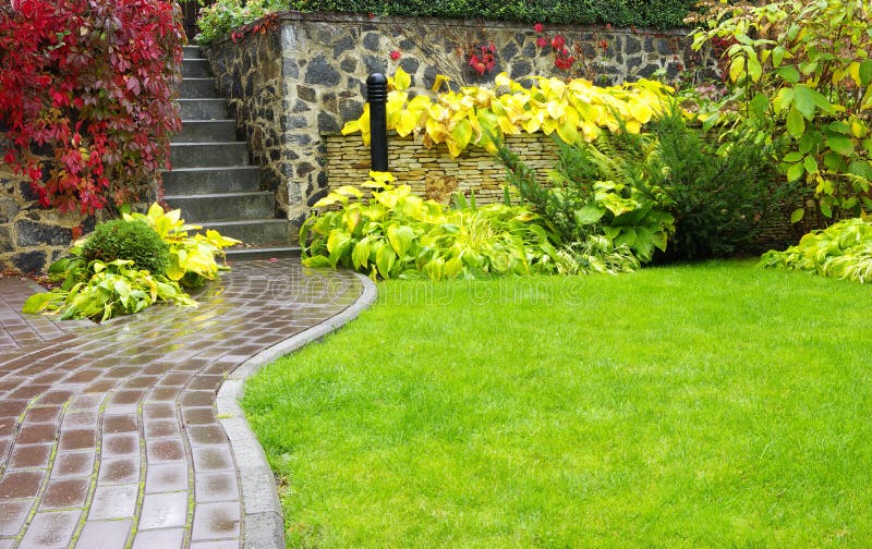 Garden stone path with grass growing up between the stones. Garden stone path with grass growing up between the stones