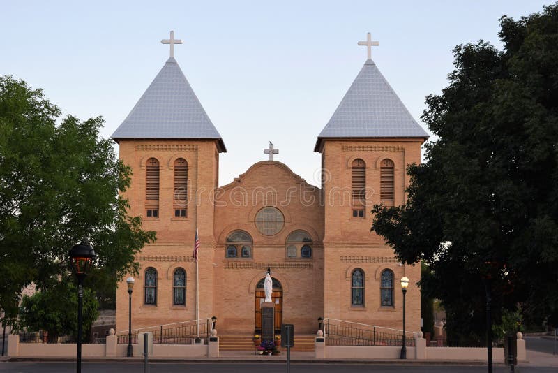 Trees on the Mesilla Plaza cuddle tan brick towers of San Albino Parish Church, on the historic plaza in Mesilla, New Mexico. Trees on the Mesilla Plaza cuddle tan brick towers of San Albino Parish Church, on the historic plaza in Mesilla, New Mexico