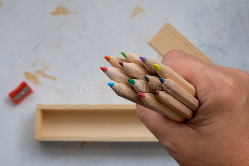 Wooden pencil case with colour pencils on a creativ grey background for back to school. Wooden pencil case with colour pencils on a creativ grey background for back to school