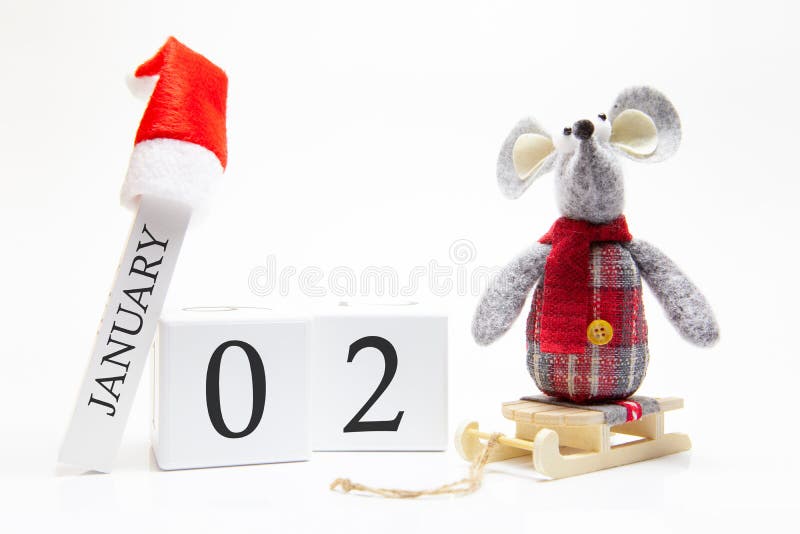 Wooden calendar with number January 2. Happy New Year! Symbol of New Year 2020 - white or metal silver rat. Christmas decorated. Wooden calendar with number January 2. Happy New Year! Symbol of New Year 2020 - white or metal silver rat. Christmas decorated