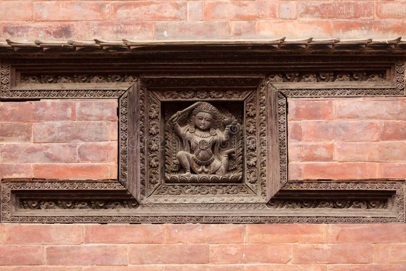 Hindu carved sculpture of guardian on temple wall, Bhaktapur, Nepal. Hindu carved sculpture of guardian on temple wall, Bhaktapur, Nepal