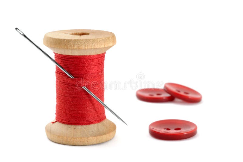 Spool of thread, needle and buttons on white background. Spool of thread, needle and buttons on white background