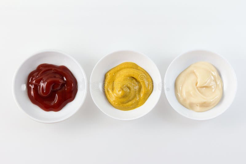 Three condiment bowls with ketchup, mustard, and mayonnaise. Three condiment bowls with ketchup, mustard, and mayonnaise