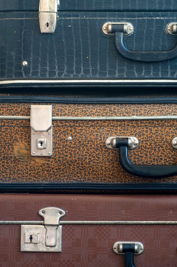 Three old closed suitcases on top of each other. Close up. Travel background. Three old closed suitcases on top of each other. Close up. Travel background.