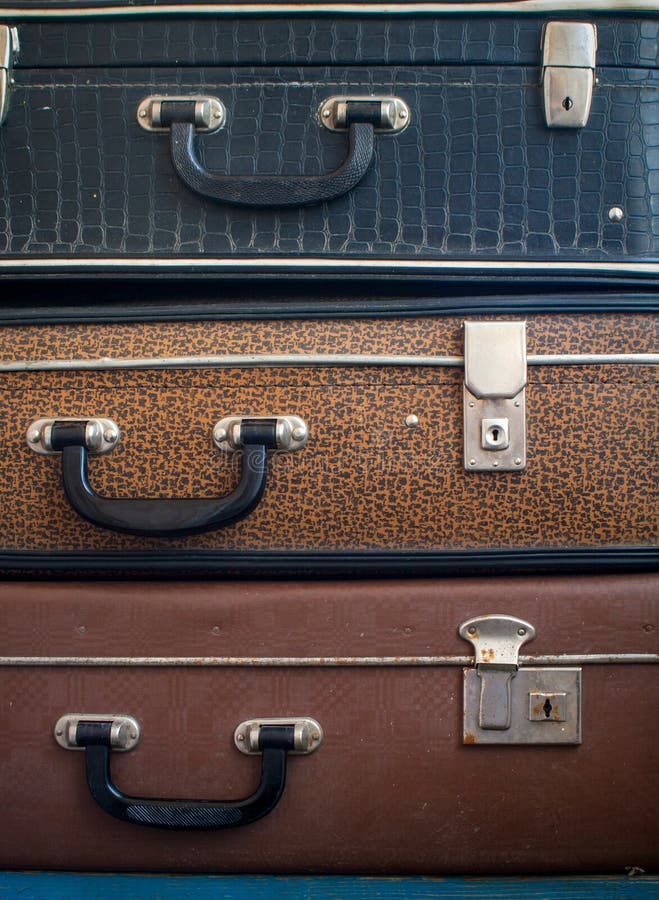 Three old closed suitcases on top of each other. Close up. Travel background. Three old closed suitcases on top of each other. Close up. Travel background.