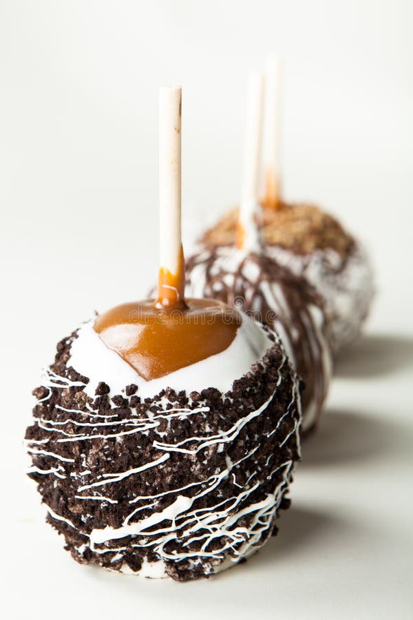 Three delicious gourmet candy apples on sticks topped with caramel, chocolate, nuts, coconut and fudge. Three delicious gourmet candy apples on sticks topped with caramel, chocolate, nuts, coconut and fudge