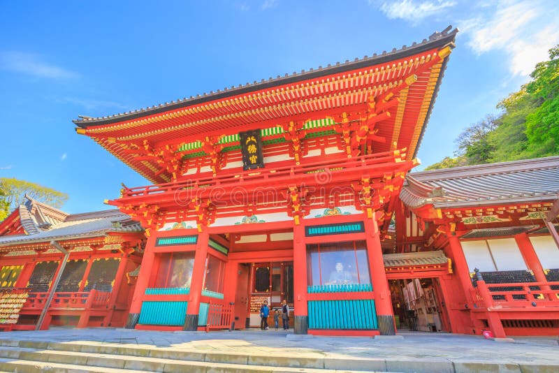 Kamakura, Japan - April 23, 2017: Romon the Great Gate at Tsurugaoka Hachiman Shinto shrine.Above the gate is a plaque bearing the name of the shrine, Hachimangu, written in 1629 by Prince Ryoujo. Kamakura, Japan - April 23, 2017: Romon the Great Gate at Tsurugaoka Hachiman Shinto shrine.Above the gate is a plaque bearing the name of the shrine, Hachimangu, written in 1629 by Prince Ryoujo.