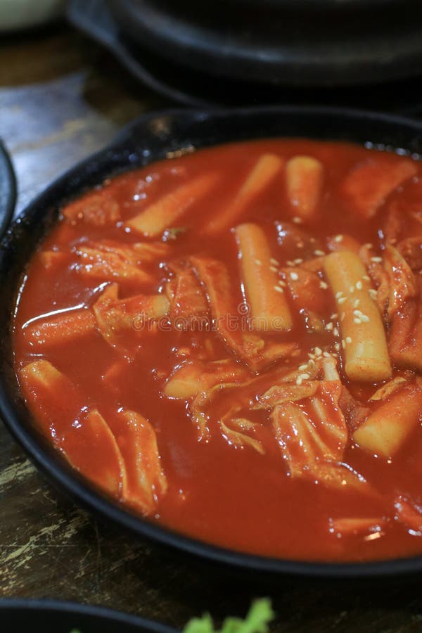 Tteokbokki in Black Plate. Korean Rice Cake Stick in Spicy Sauce Korean ...