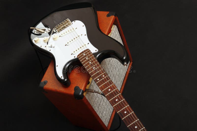 Tube Combo Amplifier for Guitar with Black Electric Guitar on Black