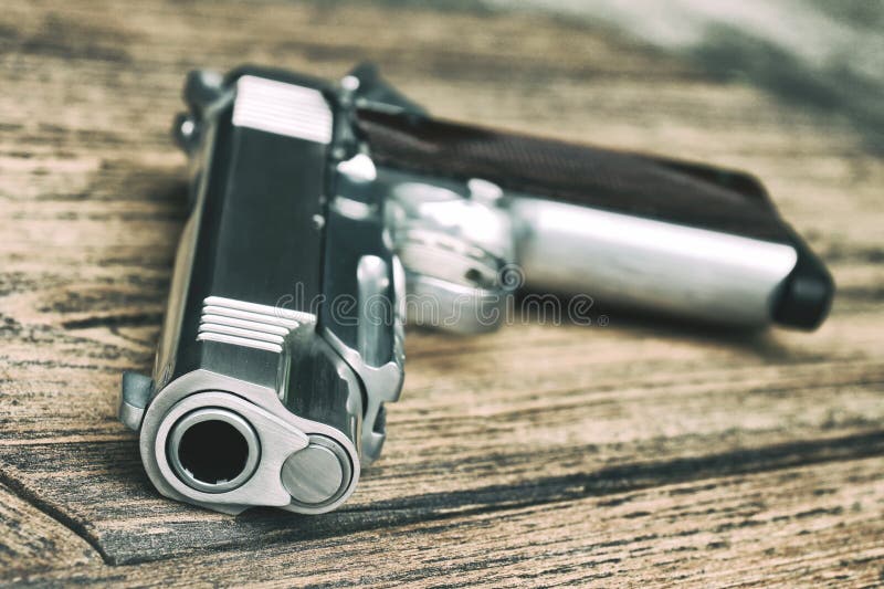 Tube de canon, 1911 modèles, pistolet semi-automatique sur le fond en bois image libre de droits Tube de canon, 1911 modèles, pistolet semi-automatique sur le fond en bois image libre de droits