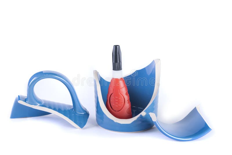 Tube of Super Glue Inside a Broken Cup that is Ready for Repair Stock