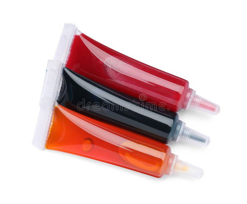 Tubes with Different Food Coloring on White Background, Top View Stock