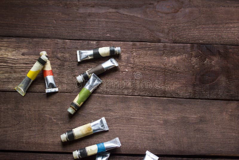Tubes of oil paint on wooden table