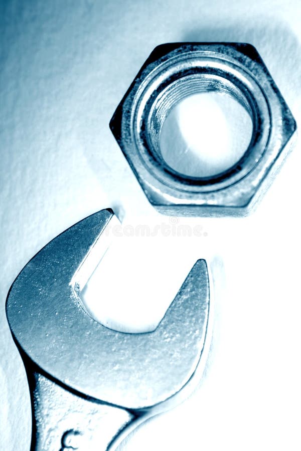 Spanner with nut on white background, closeup. Spanner with nut on white background, closeup.