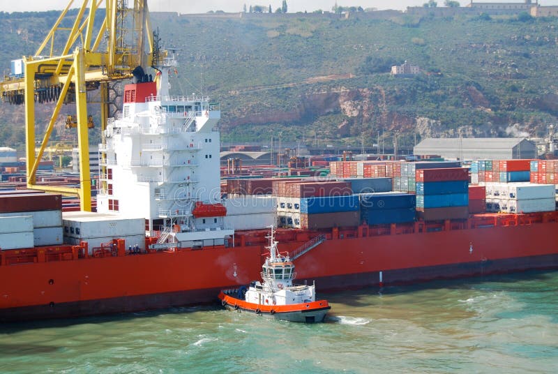 Tug Boat aligns container ship Barcelona Spain