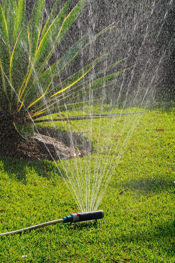 Oscillating garden sprinkler on a Mediterranean lawn, Costa del Sol, Andalucia, Spain, Western Europe. Oscillating garden sprinkler on a Mediterranean lawn, Costa del Sol, Andalucia, Spain, Western Europe.