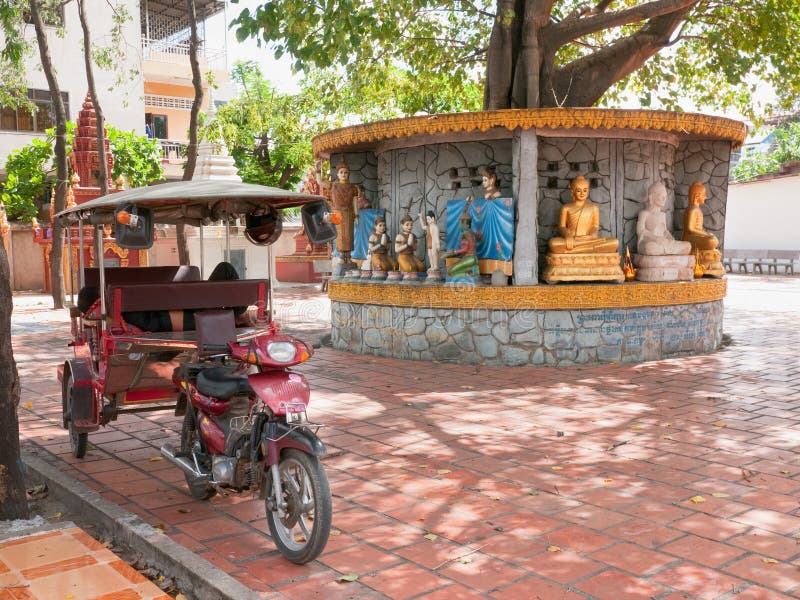 Tuk-tuk taxi at temple in Phnom Penh stock image Tuk-tuk taxi at temple in Phnom Penh stock image