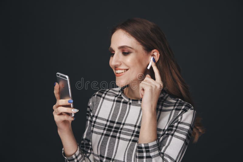 Tula, Russia - JANUARY 24, 2019: Happy woman listening music Apple AirPods