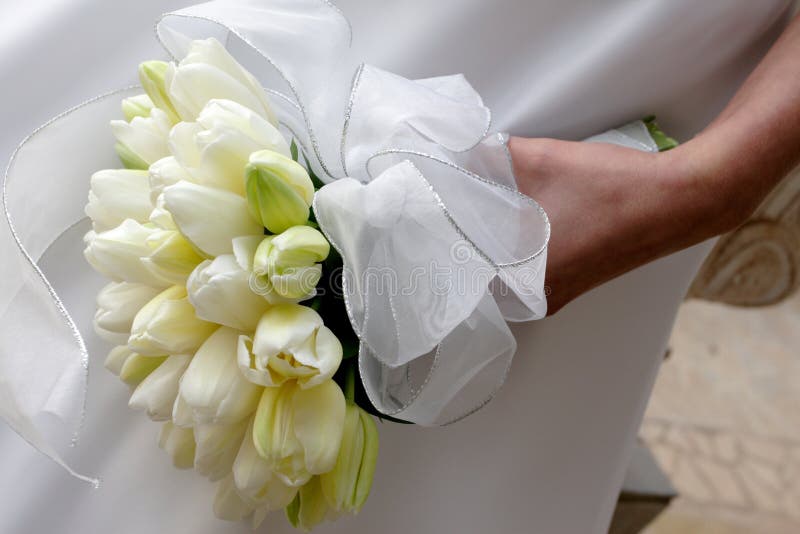 A bride holding her tulip bouquet. A bride holding her tulip bouquet