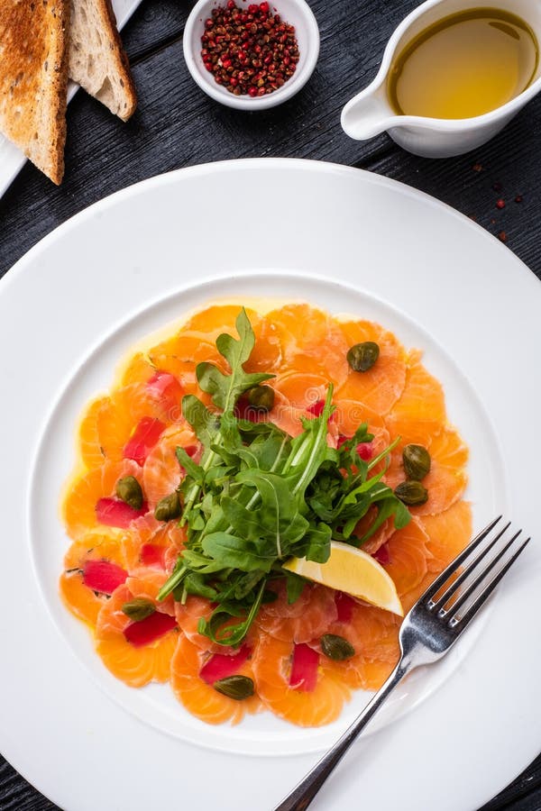 Tuna and Salmon Carpaccio with Tarragon, Capers and Lemon. Stock Photo