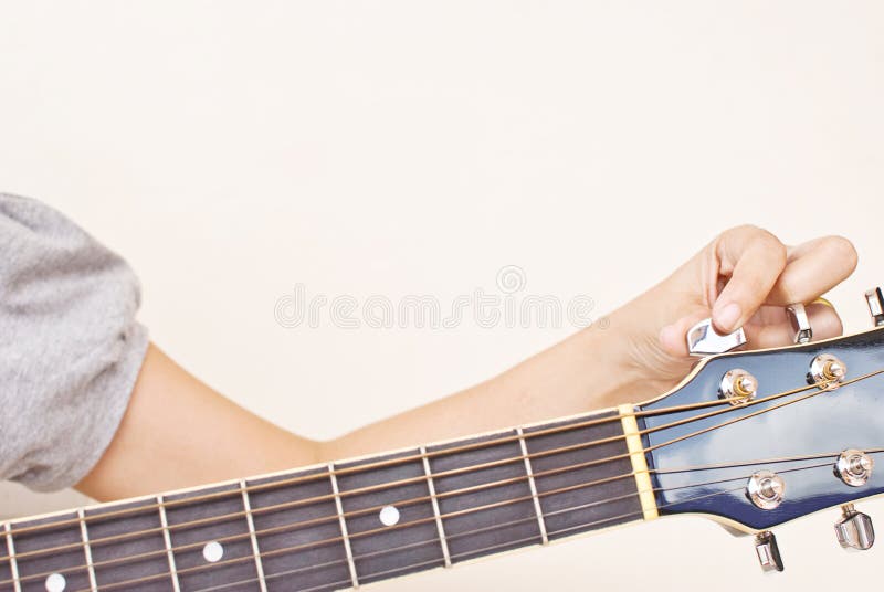 Tune up classic acoustic guitar.