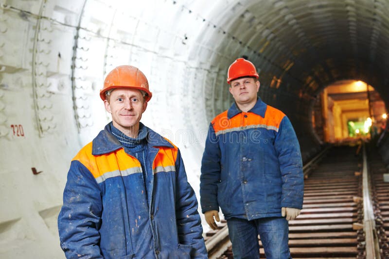 Two tunnel workers mounters at underground subway metro construction site. Two tunnel workers mounters at underground subway metro construction site