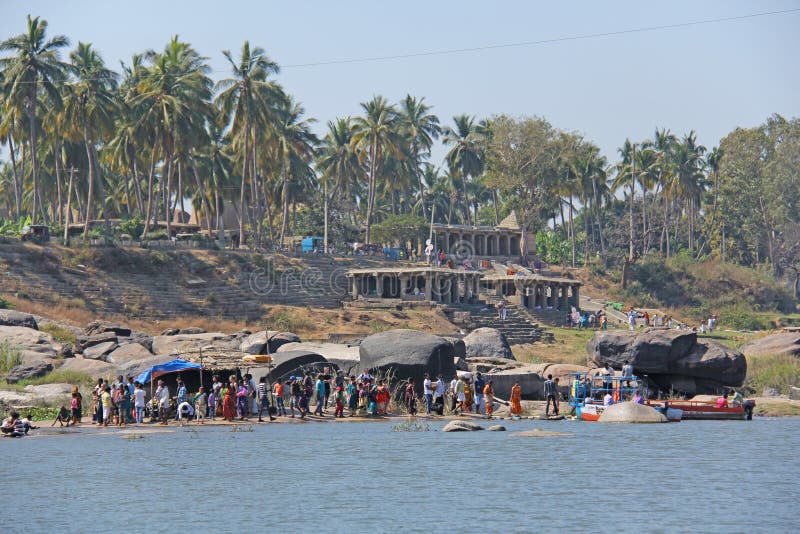 Tungabhadra river in the village of Hampi and the transfer of local residents and tourists to the other shore. Big stone. Tropical stock photo Tungabhadra river in the village of Hampi and the transfer of local residents and tourists to the other shore. Big stone. Tropical stock photo