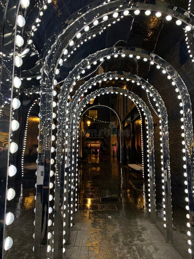 Tunnel of Mirrors and Christmas Lights in Covent Garden Stock Photo