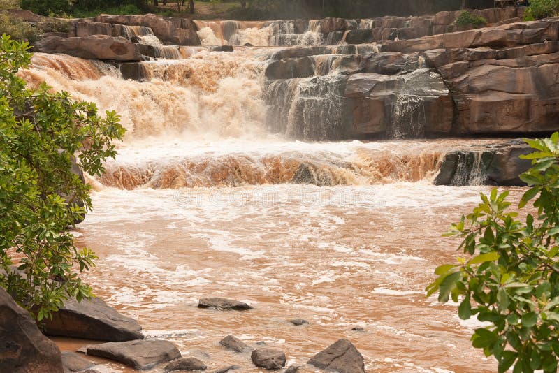 Turbid water of tropical waterfall after hard rain