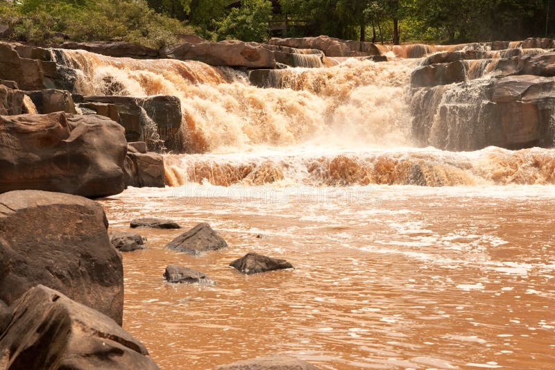 Turbid water of tropical waterfall after hard rain