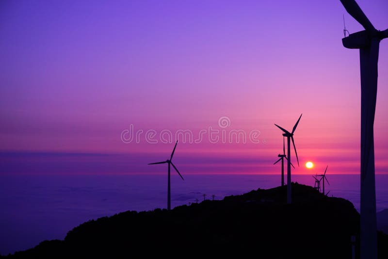 The wind turbines on the mountains at sunset are photoed when I have traveled on a high mountain. The wind turbines on the mountains at sunset are photoed when I have traveled on a high mountain.