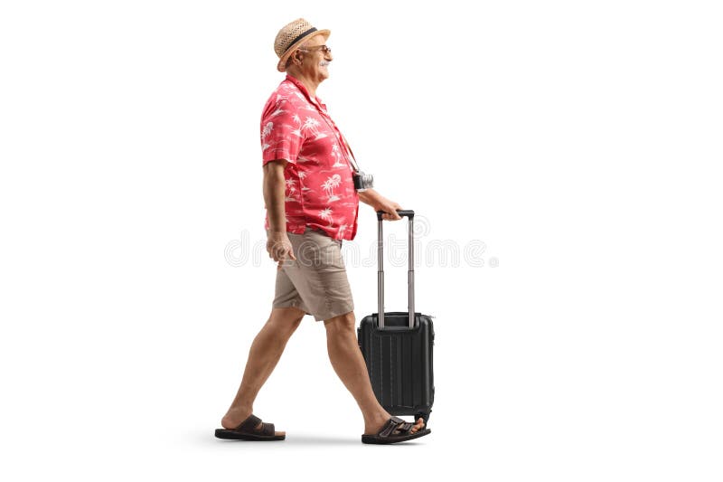 Turista masculino caminando con una pequeña maleta imagenes de archivo