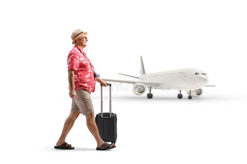 Turista masculino sacando una maleta de transporte en el aeropuerto fotos de archivo