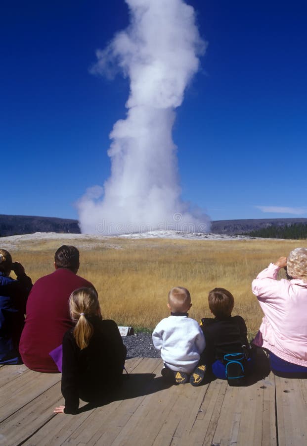 Tourists watching Old Faithful erupt at Yellowstone National Park. Tourists watching Old Faithful erupt at Yellowstone National Park.