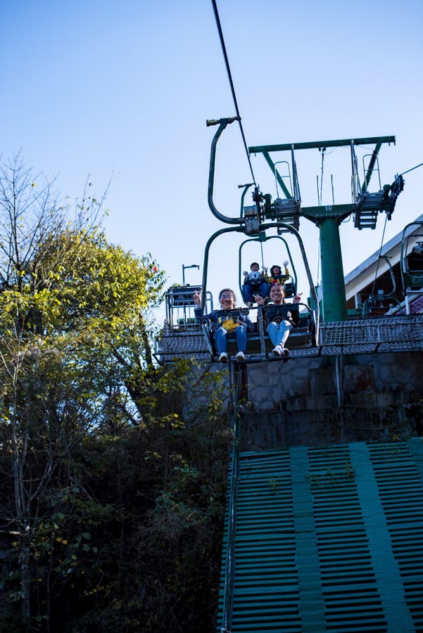 Tourists sitting on the cable car. Cable cars without protective glasses at Tianmenshan, Hunan province, Zhangjiajie. Tourists sitting on the cable car. Cable cars without protective glasses at Tianmenshan, Hunan province, Zhangjiajie.